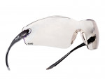 Clear safety glasses with a single wraparound lens, black arms, and an adjustable nose pad. The left arm features the brand name Bollé and HD marking. The design is lightweight and modern.
