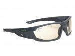 Dark gray sports sunglasses with clear lenses, a wraparound design, and the word bollé in green on the left arm. The frames have textured grips on the arms and a modern, angular style.