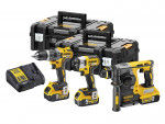 A DeWalt power tool set including a cordless drill, an impact driver, a rotary hammer, two black carrying cases, two batteries, and a battery charger, all in yellow and black.