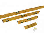 A set of yellow Stabila spirit levels in various sizes, a folding ruler, and a small keychain level, all arranged on a white background.