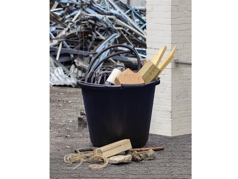 A heavy-duty plastic site bucket with a sturdy carry handle and measurement markings on the interior, for mixing and transporting materials.