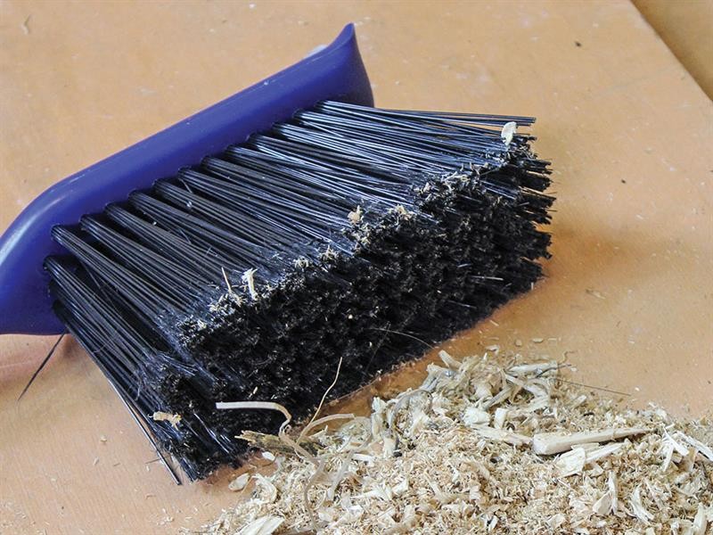 A brush with natural or synthetic bristles and an ergonomic handle, for applying coatings or cleaning surfaces.