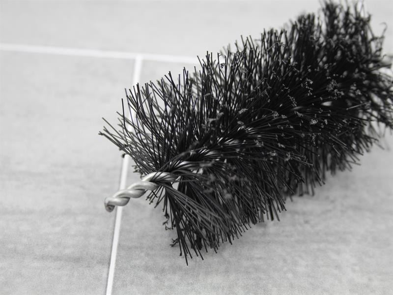 A brush with natural or synthetic bristles and an ergonomic handle, for applying coatings or cleaning surfaces.