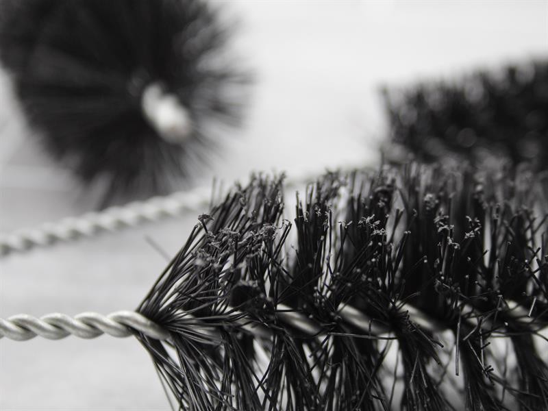 A brush with natural or synthetic bristles and an ergonomic handle, for applying coatings or cleaning surfaces.