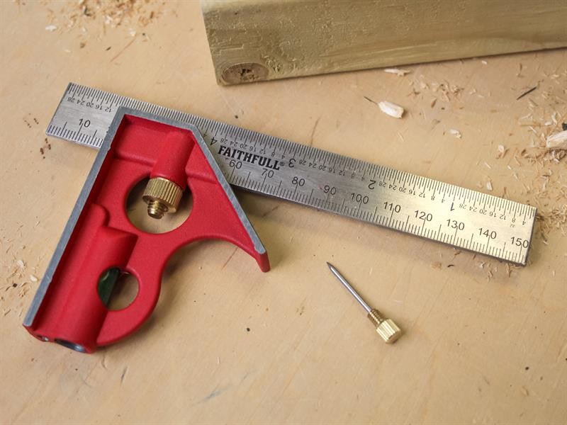 A Faithfull combination square with a graduated steel blade, a removable stock, a built-in level vial, and a scribe, for layout and checking angles.