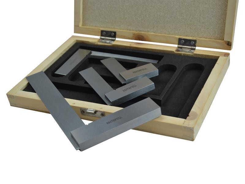 A wooden box with foam padding holds several precision engineering squares made of metal, with some placed inside the box and others resting on top. The box lid is open, revealing its contents.