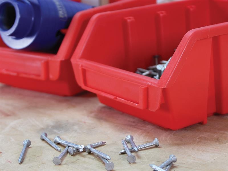 A red bins with nails in it.,