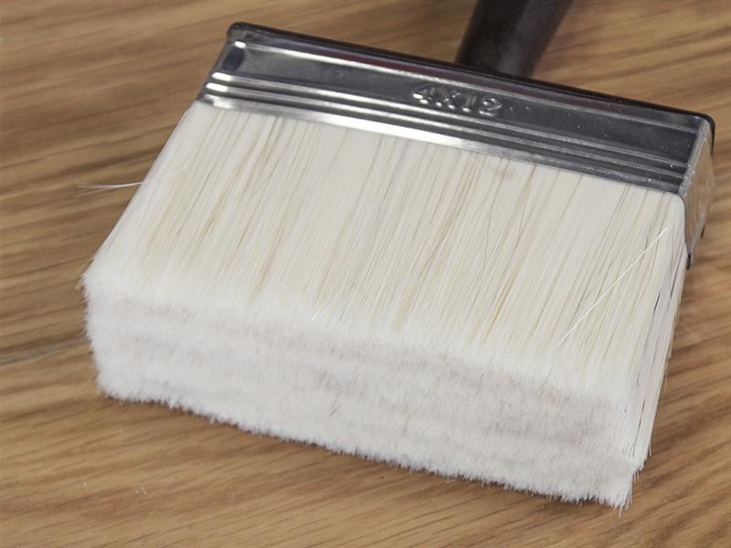A brush with natural or synthetic bristles and an ergonomic handle, for applying coatings or cleaning surfaces.