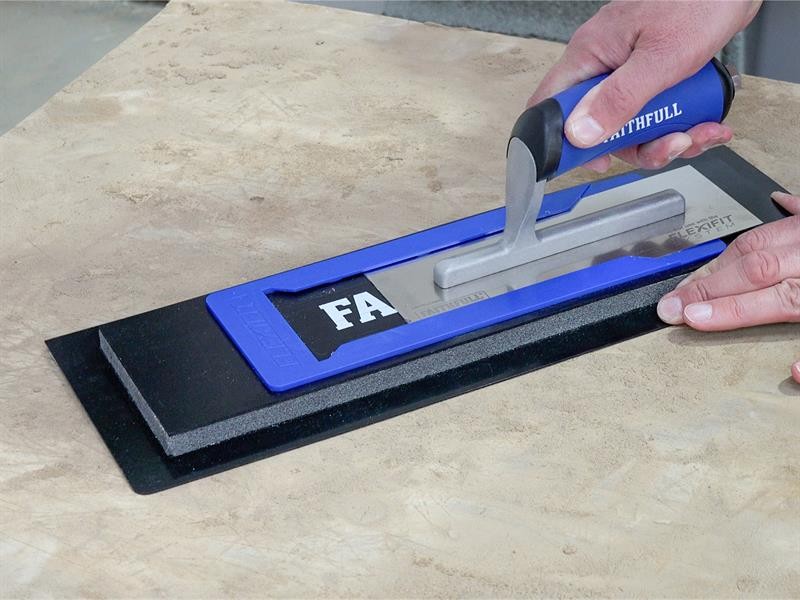 A Faithfull trowel with a polished steel blade and an ergonomic handle, for applying and finishing mortar, plaster, and adhesive.