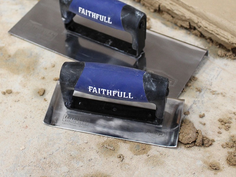A Faithfull trowel with a polished steel blade and an ergonomic handle, for applying and finishing mortar, plaster, and adhesive.