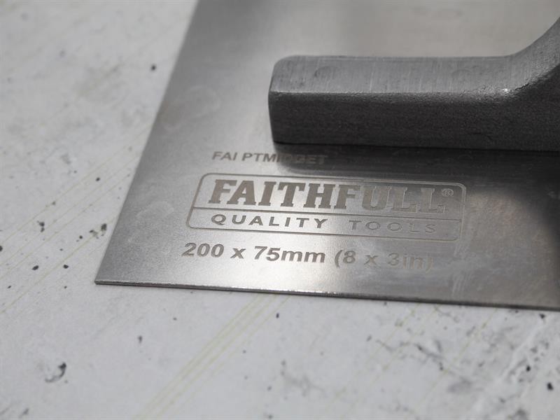 A Faithfull plasterer's finishing trowel with a thin, flexible steel blade and a turned wooden handle, for achieving smooth plaster surfaces.