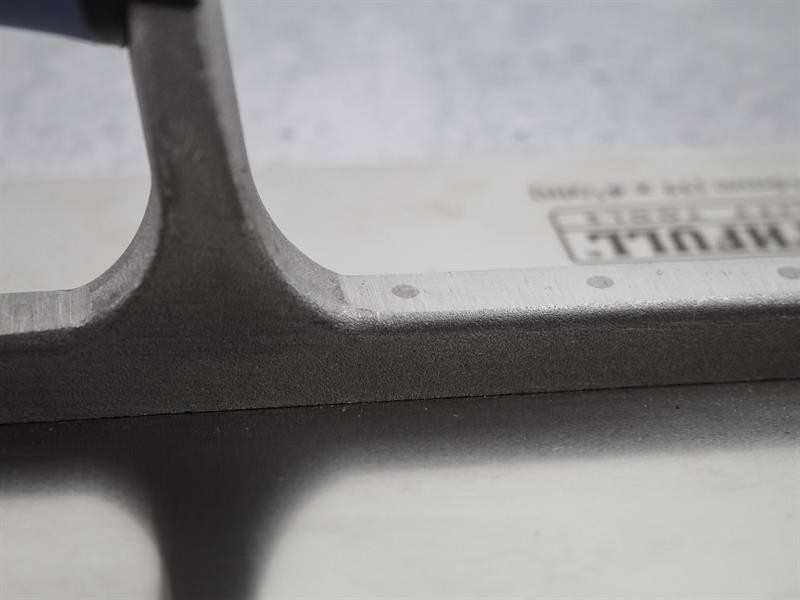 A Faithfull notched tile trowel with 115mm notches for combing adhesive on floors and walls, ensuring even coverage beneath tiles.