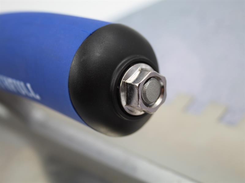 A Faithfull notched tile trowel with 115mm notches for combing adhesive on floors and walls, ensuring even coverage beneath tiles.