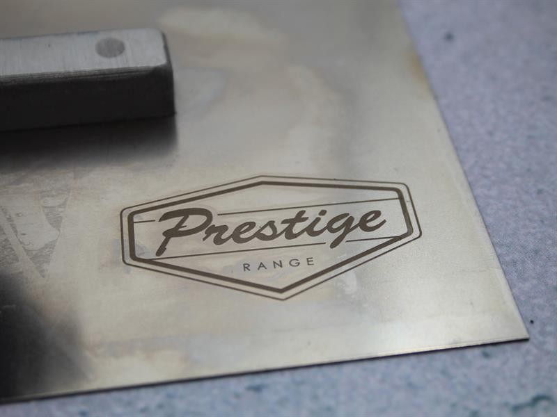 A Faithfull notched tile trowel with 115mm notches for combing adhesive on floors and walls, ensuring even coverage beneath tiles.