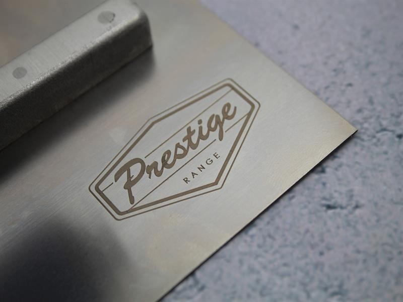 A Faithfull plasterer's finishing trowel with a thin, flexible steel blade and a turned wooden handle, for achieving smooth plaster surfaces.