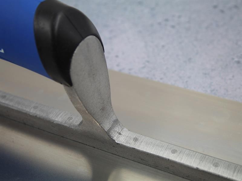 A Faithfull plasterer's finishing trowel with a thin, flexible steel blade and a turned wooden handle, for achieving smooth plaster surfaces.