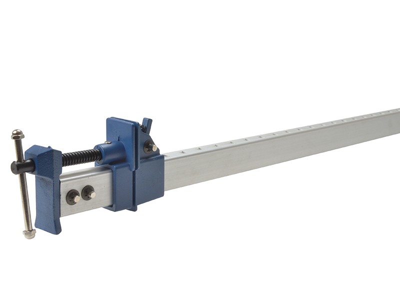 A Faithfull sash clamp with a long steel bar, a fixed jaw, and a sliding adjustable tail stop, for clamping wide assemblies during gluing.