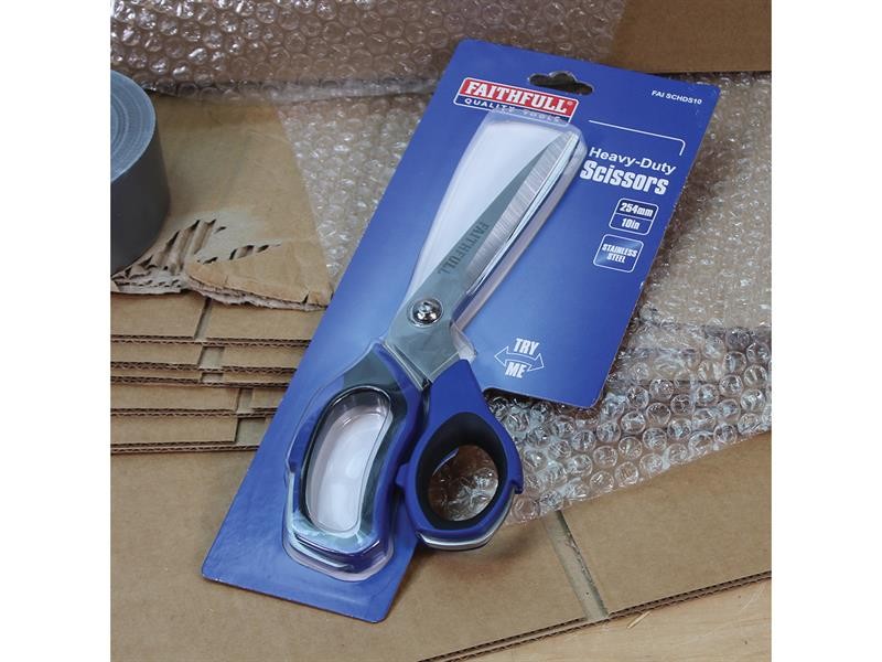 A package of Faithfull heavy-duty scissors placed on top of bubble wrap and cardboard, with a roll of duct tape partially visible in the background.