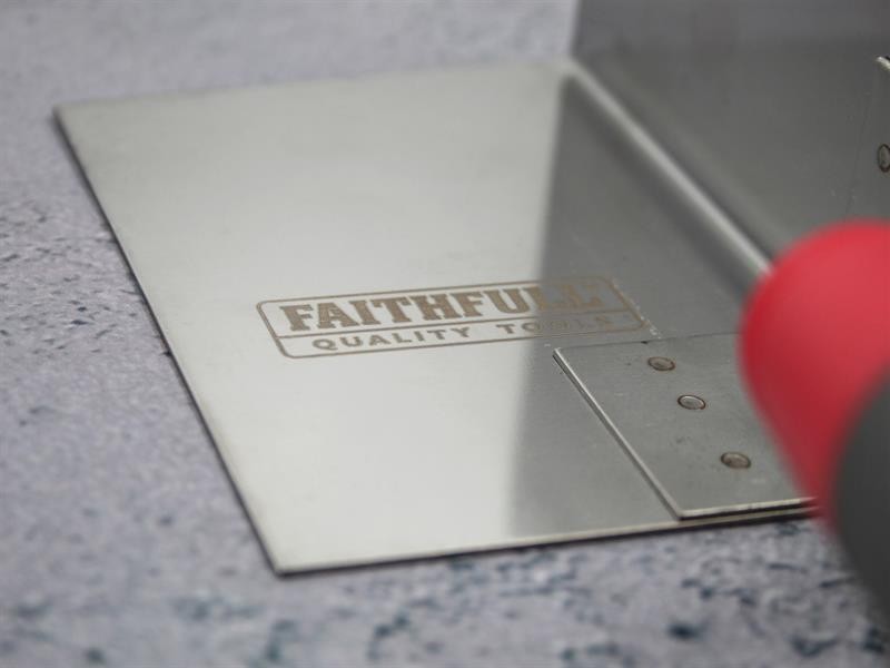 A Faithfull trowel with a polished steel blade and an ergonomic handle, for applying and finishing mortar, plaster, and adhesive.