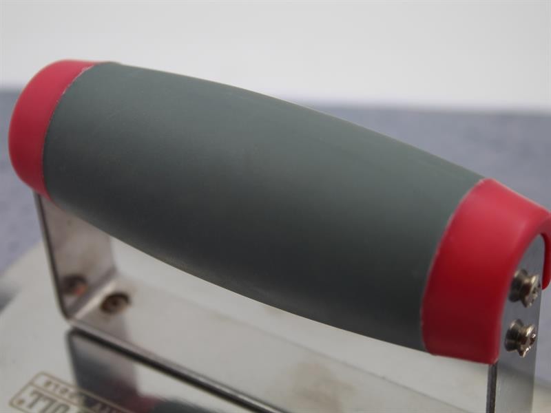 A Faithfull trowel with a polished steel blade and an ergonomic handle, for applying and finishing mortar, plaster, and adhesive.