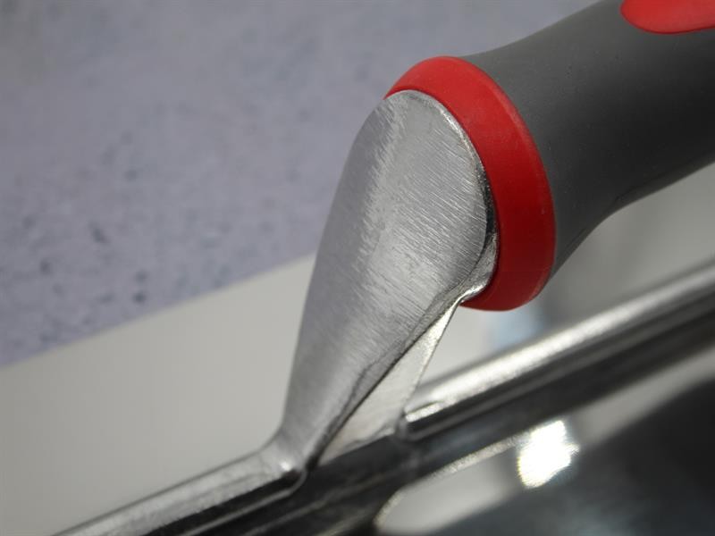 A Faithfull trowel with a polished steel blade and an ergonomic handle, for applying and finishing mortar, plaster, and adhesive.