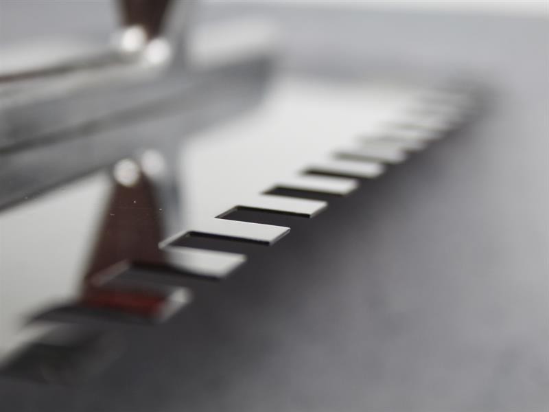 A Faithfull notched tile trowel with 10mm notches for combing adhesive on floors and walls, ensuring even coverage beneath tiles.