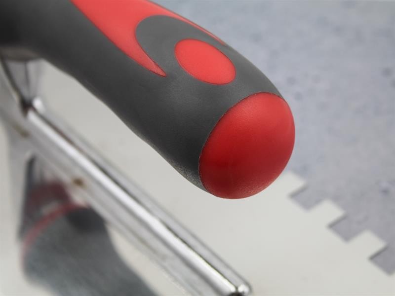 A Faithfull notched tile trowel with 10mm notches for combing adhesive on floors and walls, ensuring even coverage beneath tiles.