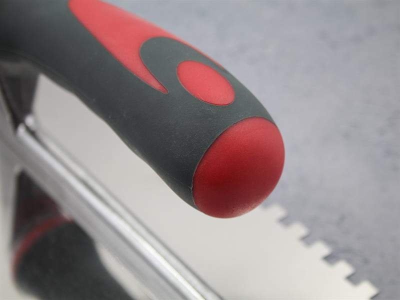 A Faithfull notched tile trowel with 6mm notches for combing adhesive on floors and walls, ensuring even coverage beneath tiles.
