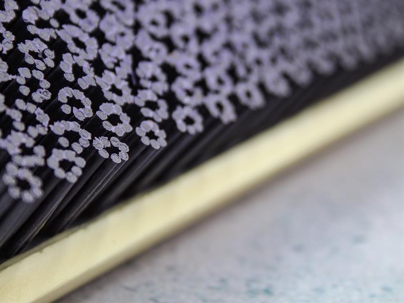 A brush with natural or synthetic bristles and an ergonomic handle, for applying coatings or cleaning surfaces.