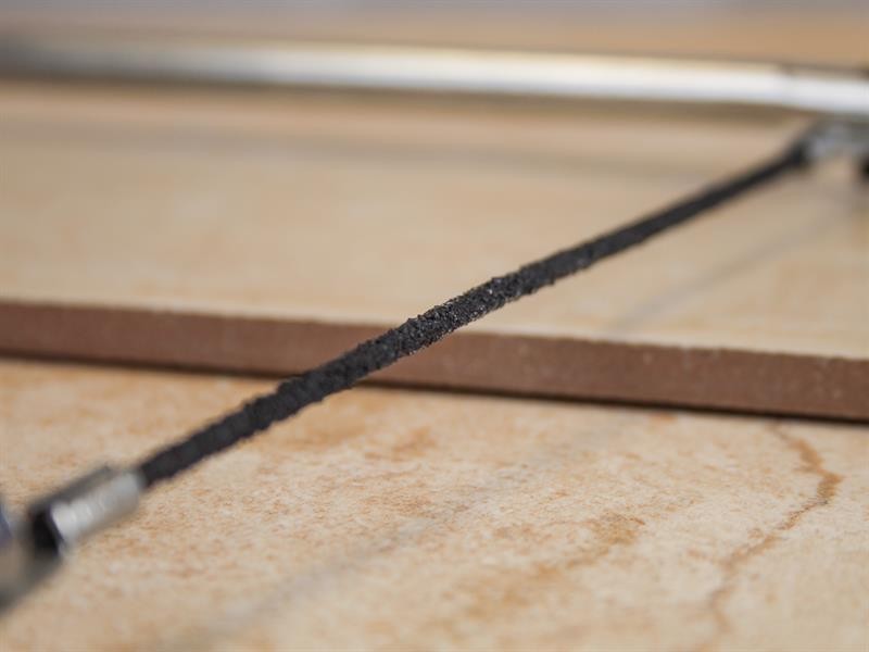 A saw with a hardened blade and a comfortable handle, for cutting timber, metal, or masonry.