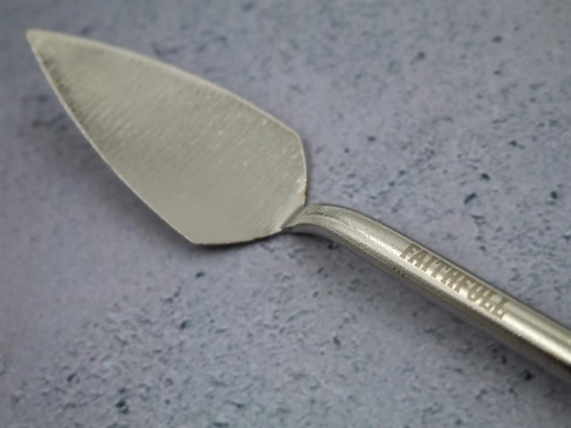 A Faithfull trowel with a polished steel blade and an ergonomic handle, for applying and finishing mortar, plaster, and adhesive.