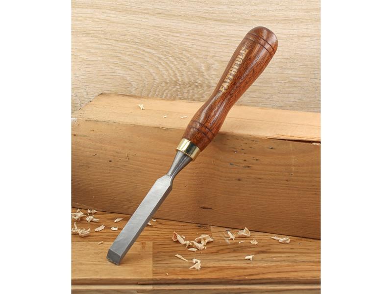 A hardened steel chisel with a bevelled cutting edge and a square-section body, for cutting stone, brick, or timber.