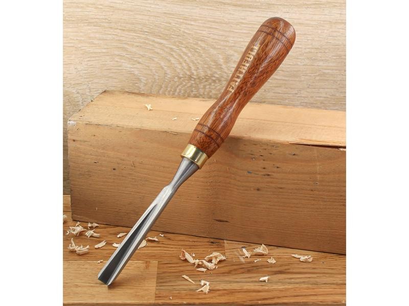 A hardened steel chisel with a bevelled cutting edge and a square-section body, for cutting stone, brick, or timber.