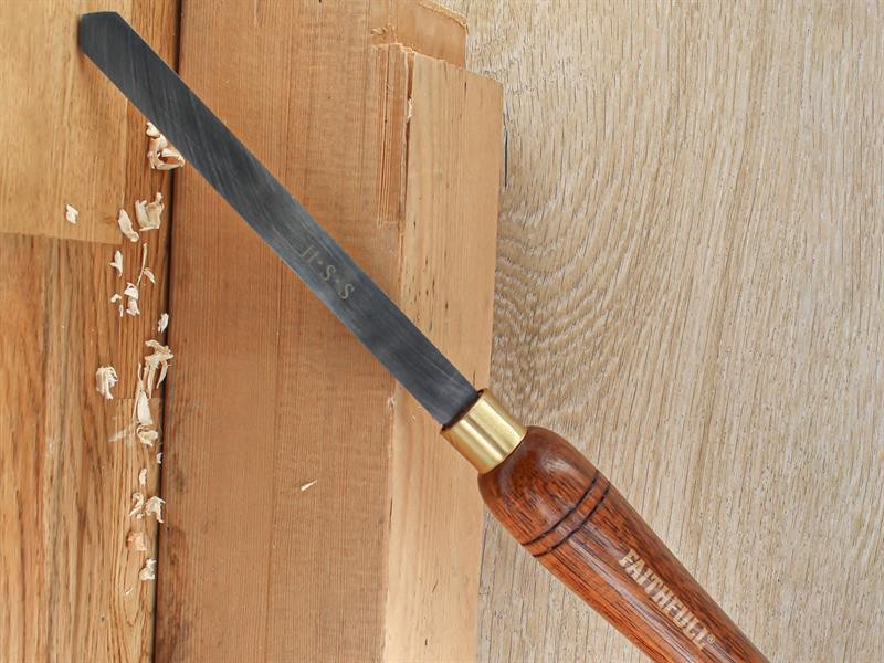 A hardened steel chisel with a bevelled cutting edge and a square-section body, for cutting stone, brick, or timber.