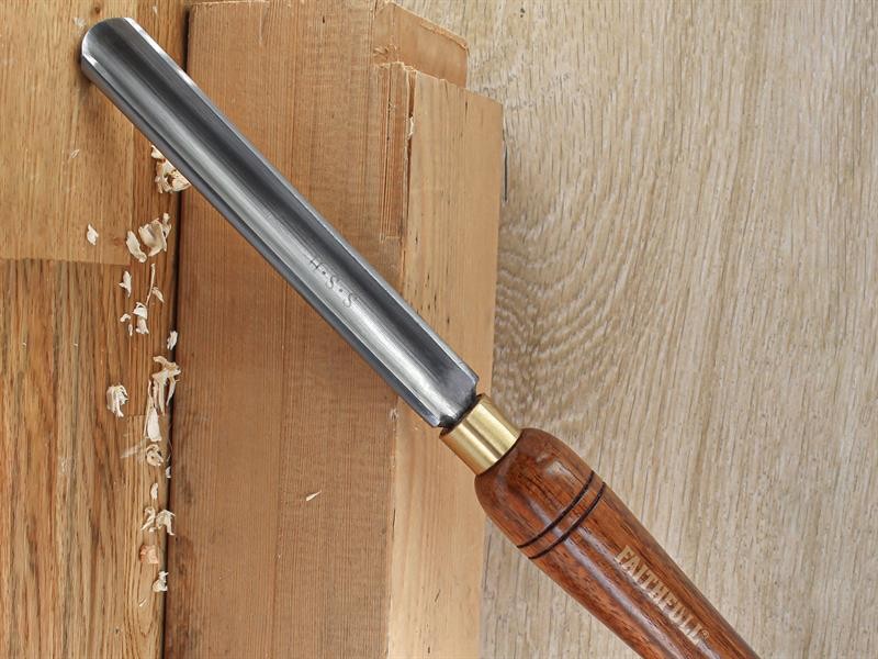 A hardened steel chisel with a bevelled cutting edge and a square-section body, for cutting stone, brick, or timber.