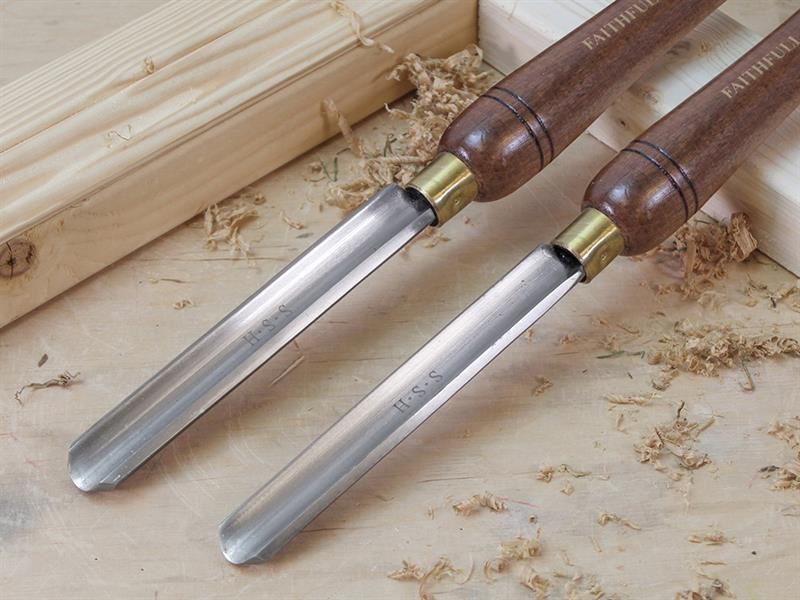 A hardened steel chisel with a bevelled cutting edge and a square-section body, for cutting stone, brick, or timber.