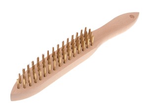 A wire brush with steel or brass bristle rows in a wooden or plastic handle, for removing rust, scale, and surface contaminants from metal.