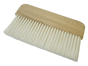 A brush with natural or synthetic bristles and an ergonomic handle, for applying coatings or cleaning surfaces.