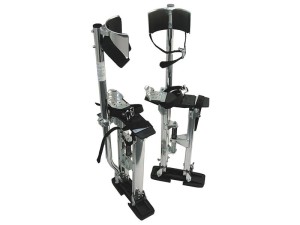 A pair of adjustable drywall stilts made of metal with black footplates, calf supports, and straps, designed for construction or painting work to reach higher areas safely.