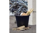 A heavy-duty plastic site bucket with a sturdy carry handle and measurement markings on the interior, for mixing and transporting materials.