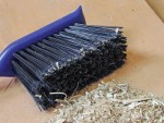 A brush with natural or synthetic bristles and an ergonomic handle, for applying coatings or cleaning surfaces.