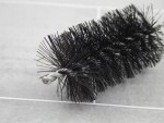 A brush with natural or synthetic bristles and an ergonomic handle, for applying coatings or cleaning surfaces.