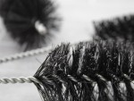 A brush with natural or synthetic bristles and an ergonomic handle, for applying coatings or cleaning surfaces.
