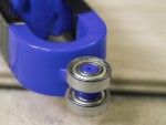 A Faithfull needle file with a hardened steel abrasive surface and a turned wooden or synthetic handle, for shaping and deburring metal.