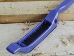 A Faithfull needle file with a hardened steel abrasive surface and a turned wooden or synthetic handle, for shaping and deburring metal.