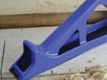 A Faithfull needle file with a hardened steel abrasive surface and a turned wooden or synthetic handle, for shaping and deburring metal.