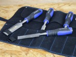 A hardened steel chisel with a bevelled cutting edge and a square-section body, for cutting stone, brick, or timber.