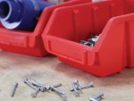 A red bins with nails in it.,