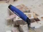 A Faithfull trowel with a polished steel blade and an ergonomic handle, for applying and finishing mortar, plaster, and adhesive.