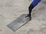 A Faithfull margin trowel with a rectangular steel blade, designed for spreading adhesive and working in confined spaces.